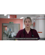 A still from the video. A nurse in her uniform. Text reads "reducing the number of people who come to a hospital A&E"