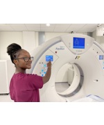 Radiographer Annie Murambiwa with a new CT scanner at Wirral Diagnostics Centre